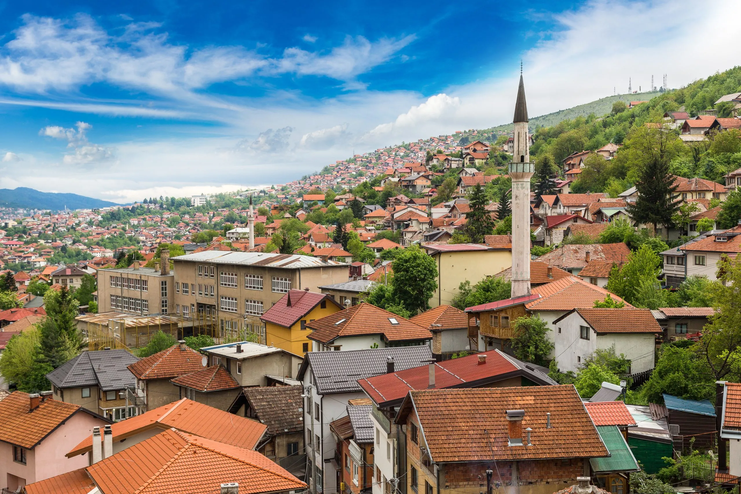 view of sarajevo bosnia and herzegovina skyline on a sunny day with a minaret prominent. old town is packed with some of the best things to do in sarajevo