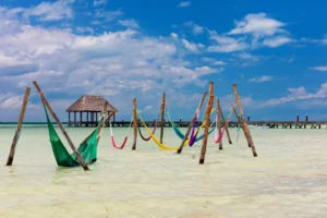 group of colorful hammocks in the water--relaxing here is among the best things to do on isla holbox mexico