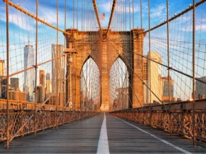 view on the brooklyn bridge facing manhattan on a sunny morning, one of the top attractions on a 2 day weekend in new york itinerary