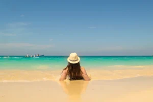 kate storm in a sunset laying on the edge of playa blance cartagena colombia beach