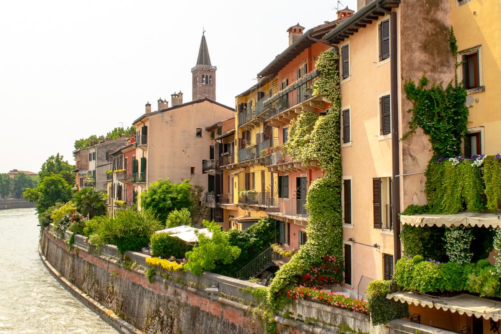 view of houses along the adige river as seen from ponte pietra, one of the best things to do in verona italy